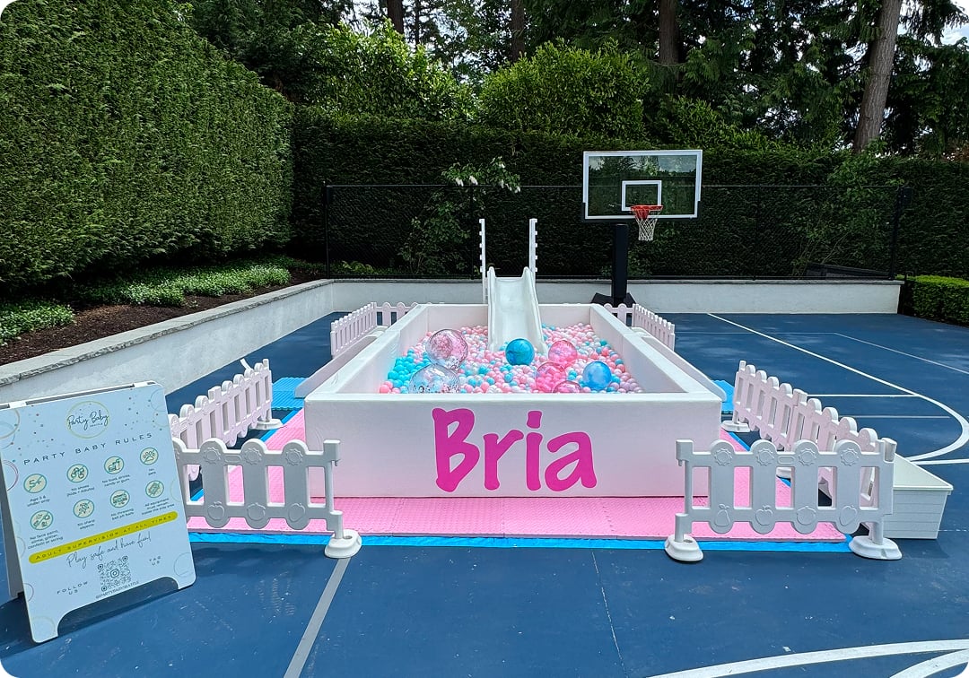 Custom ball pit rental in Bellevue with pink name decal and thousands of colorful balls for a birthday party