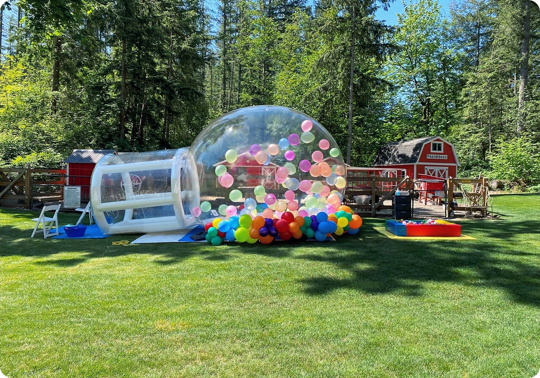 Bellevue bubble house rental filled with colorful balloons for outdoor birthday celebrations