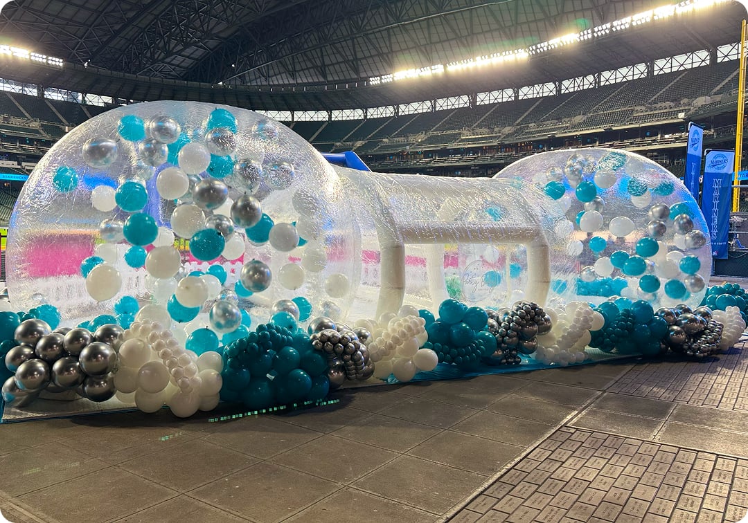 Corporate event setup in Bellevue with clear inflatable domes and balloon décor at a large venue