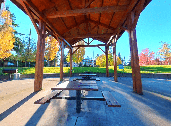 Crossroads Park International Shelters 1-3 picnic area with covered tables and open green space in Bellevue, Washington