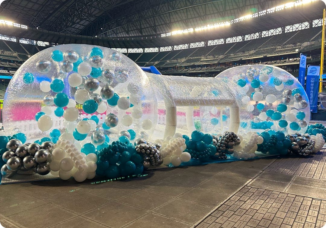 Corporate event setup in Seattle featuring balloon décor and Bubble House inside stadium venue.
